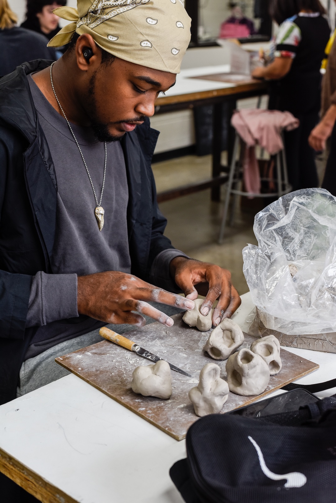 K. O'Neill in 2022 working with clay in a Foundations course at the College for Creative Studies.